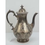 A large and impressive Victorian HM silver coffee pot having engraved floral decoration throughout
