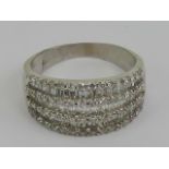 An 18ct white gold and diamond cocktail ring having three rows of baguette cut diamonds separated