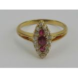 A ruby and diamond cluster ring having three central graduated rubies surrounded by diamonds,