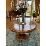A rosewood circular centre table having
