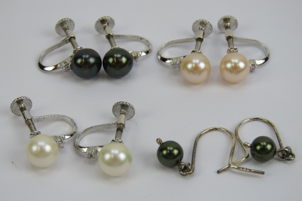 Four pairs of silver and pearl earrings