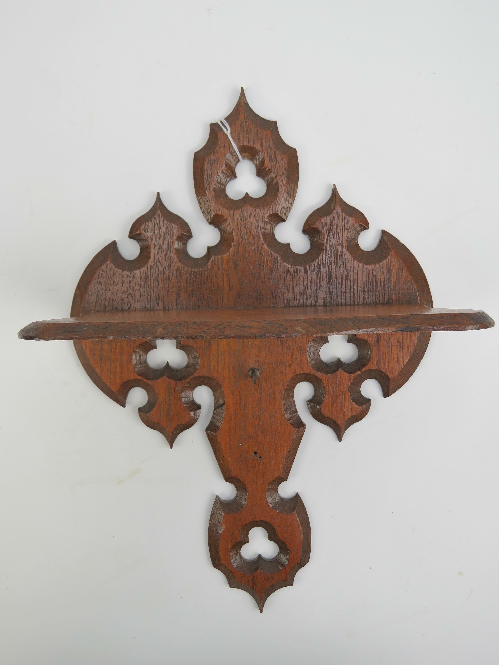 A Gothic revival hall shelf having pierc