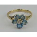 An aquamarine and diamond daisy cluster