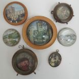 Four glass paperweights, two within wood