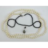 A strand of individually knotted pearls,