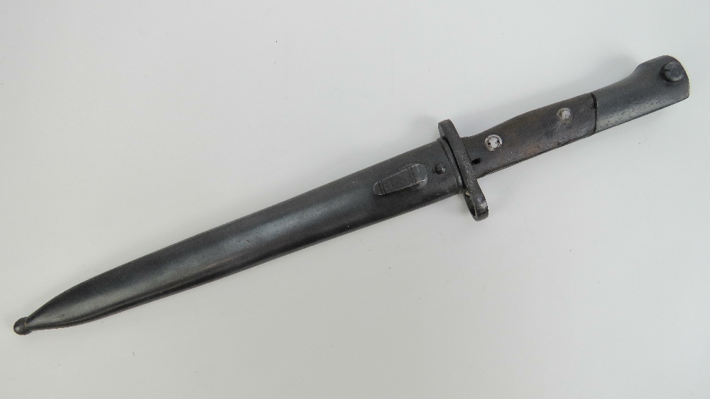 A Mauser Ugo 1944 bayonet with scabbard measuring 40cm in length.