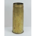 A brass shell case dated 1974 and stamped '76mm ARMDC RW175 RLB LOT 10' with broad arrow to base.