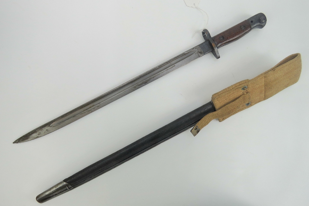 A WWI British Lee Enfield rifle 1907 pattern bayonet, dated 1916 in scabbard with canvas hanger. - Image 2 of 5