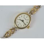 A 9ct gold ladies wristwatch on 9ct white and yellow gold strap, the white dial marked for W.