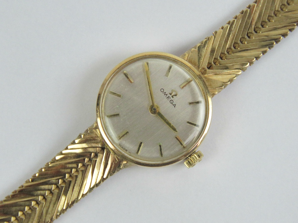 A 9ct gold ladies Omega cocktail wristwatch complete with integral 9ct gold strap, hallmarked 375,