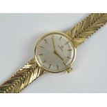 A 9ct gold ladies Omega cocktail wristwatch complete with integral 9ct gold strap, hallmarked 375,