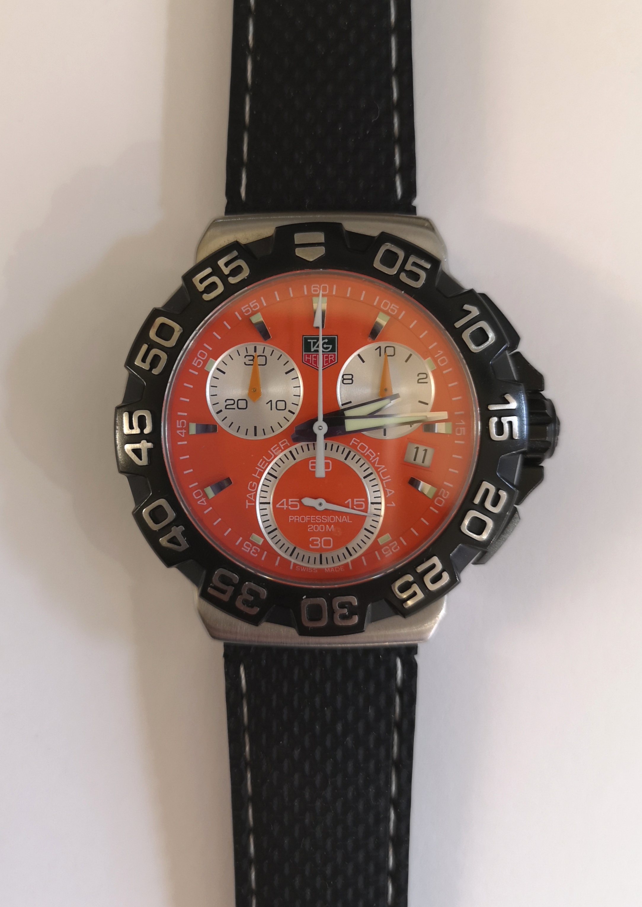 A Tag Heuer Formula 1 2009 wristwatch having orange dial with three subsidiary dials and date