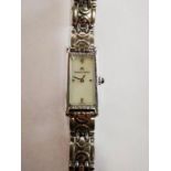 A Maurice Lacroix ladies coctail watch having rectangular white dial with white hands,