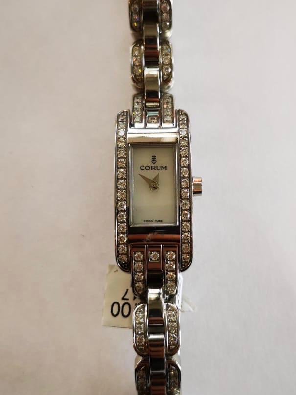 A Corum ladies cocktail watch in the art deco style, encrusted with round cut brilliant diamonds,