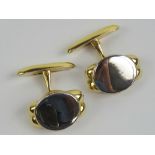 A pair of 18ct white and yellow gold cufflinks having oval front panel in white gold, unengraved,