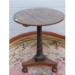 A mid 19th century circular tilt top rosewood side table raised over a twisted and gadrooned stem