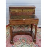 A 19th century Empire style escritoire writing desk having twin embossed leather fronted cardboard