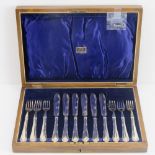 A wooden canteen containing a set of six silver plated fish knives and forks,