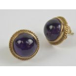 A pair of 9ct gold amethyst cabachon stud earrings, each 1.4cm dia, hallmarked 375, total weight 4.