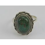 A silver and bloodstone ring, central oval cabachon measuring 13 x 9mm, stamped 925, size S-T.