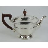 A HM silver teapot having partially gadrooned body and lid,