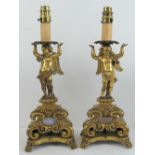 A superb pair of ormolou candlesticks later converted for use as electric lights,