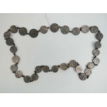 A necklace comprising thirty graduating Arabic white metal coins, 11.75ozt.