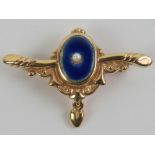 An 18ct gold brooch having blue enamel to central oval panel set with single seed pearl and having
