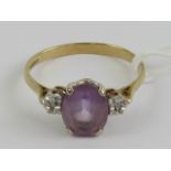 A 9ct gold amethyst and diamond ring, the central oval cut amethyst measuring approx 8.8 x 6.8 x 4.