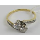 A delightful vintage two stone diamond ring,