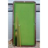 A vintage Atlas quarter sized tabletop snooker table complete with queues and rests,
