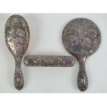 A HM silver dressing table set comprising hand mirror and brushes,