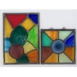 Two coloured glass leaded panels measuring 19.5 x 20cm and 20.5 x 29cm respectively.