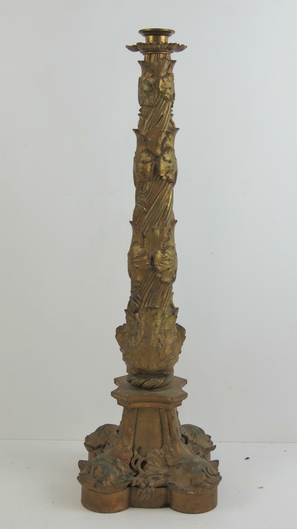 A heavy cast gilt bronze single candlestick with grape and vine decoration throughout, 56cm high.