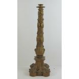 A heavy cast gilt bronze single candlestick with grape and vine decoration throughout, 56cm high.