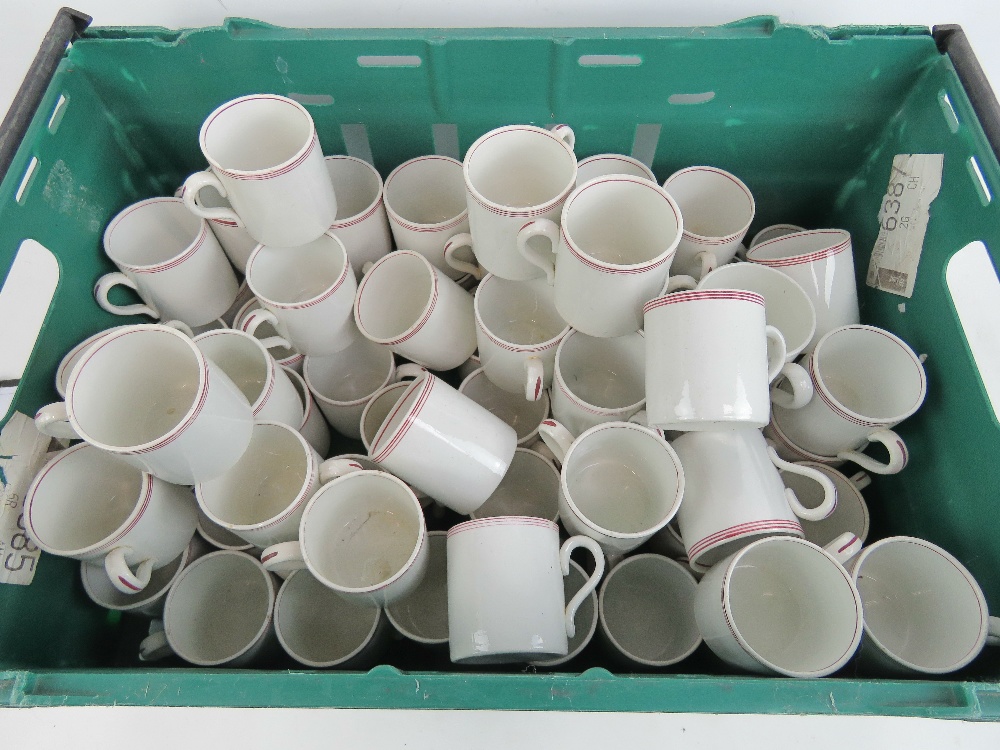 A very large quantity of identical cream ground mugs each with handle and striped decoration to lip.