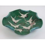 A Chinese porcelain 19th century pentafoil dish moulded in relief and having seven cranes upon,