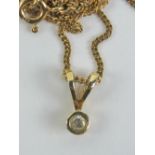 A 9ct diamond solitaire pendant, the round cut brilliant diamond in rubover mount, hallmarked 375,