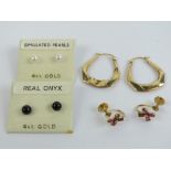 A pair of 9ct gold screw back earrings having red stone flower upon,