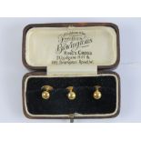A set of three 18ct gold shirt studs in original fitted box for Bravingtons Kings Cross, 2.3g.