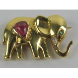 A yellow metal brooch in the form of an elephant having ruby to body, diamond tusk and emerald eye,