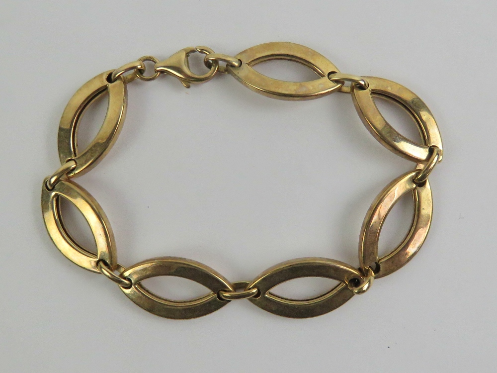 A 9ct gold bracelet having seven open oval shaped panels, hallmarked 375, 18.