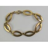 A 9ct gold bracelet having seven open oval shaped panels, hallmarked 375, 18.