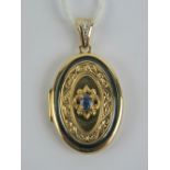 A 14ct gold oval shaped locket having central oval cut Ceylon blue sapphire and single diamond to