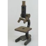 A Negretti & Zambra London Rigior III 727055 microscope having two lenses, adjustable height,