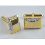 A pair of 18ct gold cufflinks having plain front with semi-circle of diamonds to top and bottom,