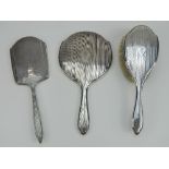 A HM silver dressing table hand mirror and hairbrush set, each hallmarked for Chester.