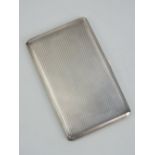 A HM silver cigarette case having engine turned decoration to front and back,