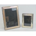 A pair of HM silver graduated photograph frames, 18 x 13cm and 11.