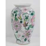 An Oriental vase having white ground with pink and green floral and butterfly decoration upon,